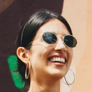Woman smiling with healthy teeth, showcasing results of a comprehensive oral care routine
