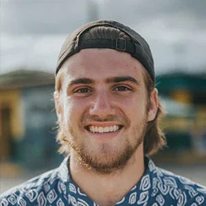 Man smiling with healthy teeth, showcasing results of a comprehensive oral care routine using premium dental tools.