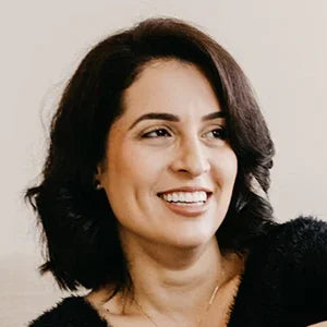 Woman smiling with healthy teeth, showcasing results of comprehensive oral care routine