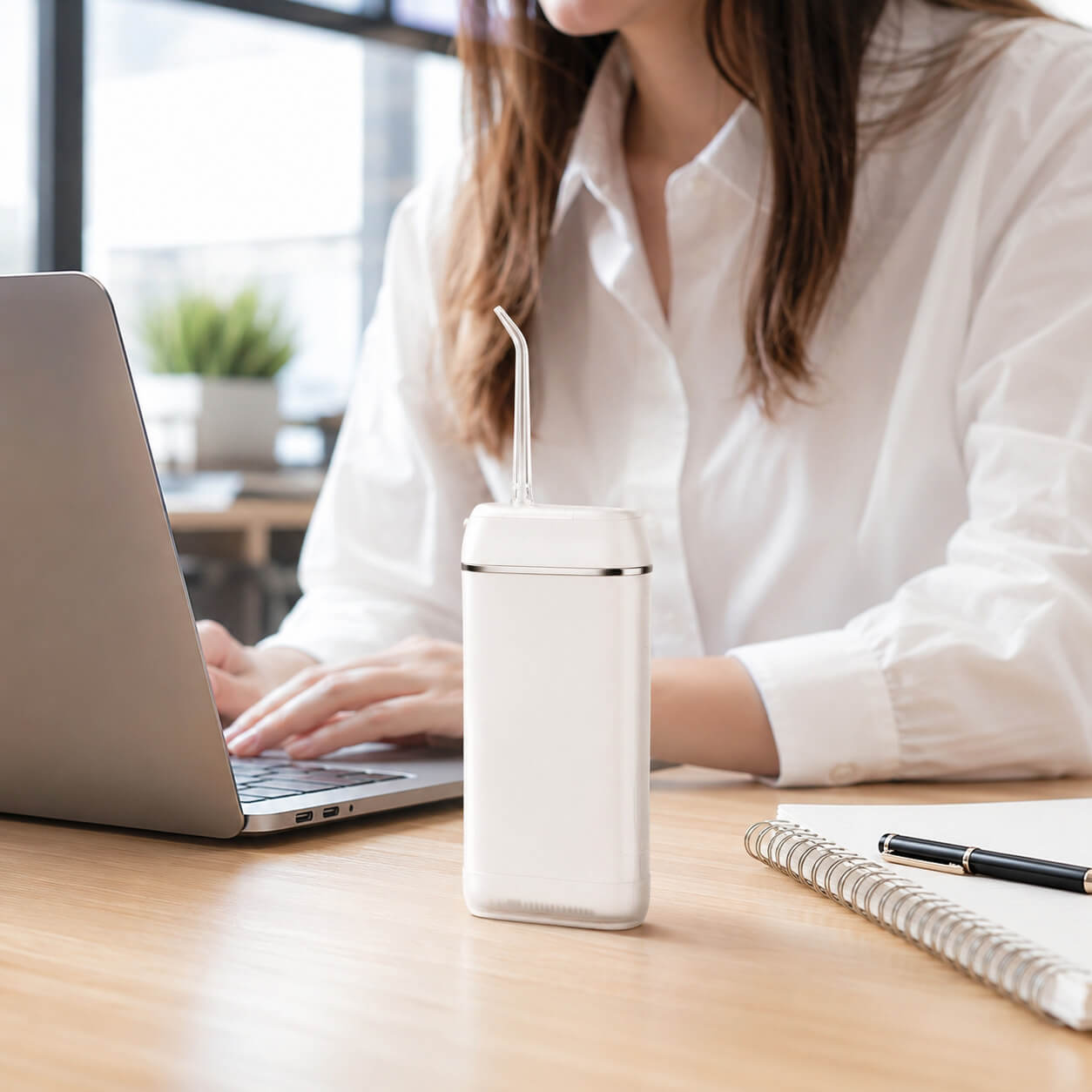 A discreet, pocket-sized orthodontic cleaning kit containing a travel toothbrush and a portable water flosser resting on a school or office desk.